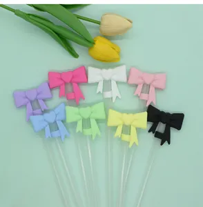 Close-up detail of cute heart bow silicone straw covers for 10mm cups, colorful multi-pack.
