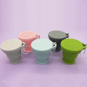 Portable 180ml collapsible silicone travel water cup with paw print lid and carabiner.