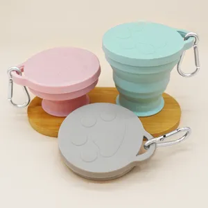 Portable collapsible silicone travel cup with carabiner and cute paw print design.