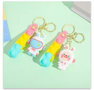 Cute cartoon space rabbit astronaut keychain with colorful pop it strap and metal ring.