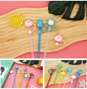Close-up of cute cartoon silicone straw covers with animal and fruit designs for 8mm straws.
