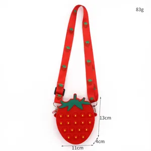 Red silicone strawberry pop it crossbody bag with cute strap and size specs for kids daily use.