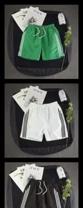 Details of casual summer loose fit sports shorts with side stripes and elastic waistband.