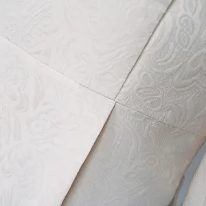 Close-up view of vintage men coat jacquard fabric texture, elegant medieval costume detail.
