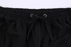 Close-up view of men's casual pants elastic drawstring waistband in black fabric detail.