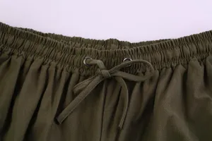 Close-up detail shot of men's casual trousers elastic waistband with adjustable drawstring.