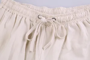 Close-up view of men's casual linen trousers elastic waistband with adjustable drawstring.