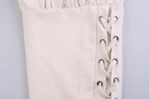 Close-up detail of men's casual linen pants featuring metal eyelet lace-up and gathered cuff.