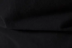 Close-up detail shot of the soft cotton linen fabric texture showcasing fine textile weave.