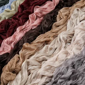 Close-up detail of tencel pleated fabric scarf texture showing multiple vibrant color choices.