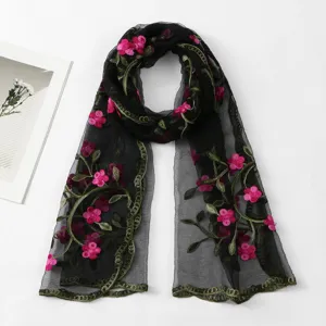 Detailed close-up of the black sheer embroidered long scarf with vibrant pink floral patterns.