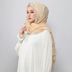 Detailed view of the elegant chiffon hijab featuring exquisite lace floral edge trim, soft texture.