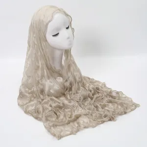 Detailed view of lightweight crinkled beige long scarf, showing soft textured fabric drape.