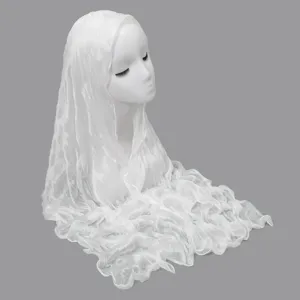 Detailed view of the elegant white crinkled long scarf draped gracefully on model.
