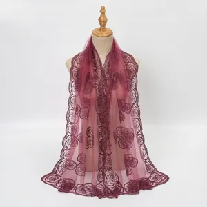 Close-up detail of sheer lace scarf featuring exquisite rose embroidery and breathable mesh fabric.