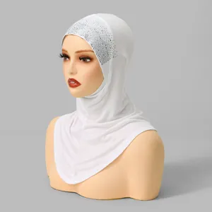 Close-up details of the elegant white rhinestone hijab cap featuring sparkling crystal accents.