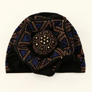 Detailed close-up view of the sparkling rhinestone and stud pattern on the black turban hat.