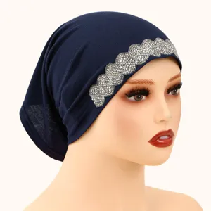 Close-up detail of dark blue women's rhinestone turban hat, comfortable polyester base.