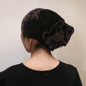 Back detail of black rhinestone turban cap, stylish floral design, soft breathable chemo hat for women.