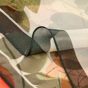 Closeup detail view of women floral printed sheer chiffon scarf fabric texture and hem