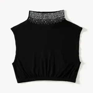 Close-up of black detachable mock neck collar featuring sparkling rhinestone embellishments.