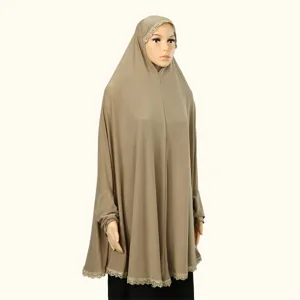 Detail view of the elegant Muslim hijab abaya, featuring delicate lace embroidery trim and sleeves.