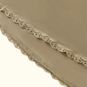 Close-up view of ethnic style hijab showcasing exquisite gold lace embroidery details.