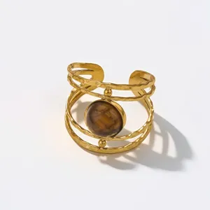 Close-up of vintage hammered gold open ring with round brown tiger eye stone