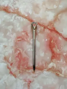 Elegant silver metal ballpoint pen featuring a large clear crystal diamond top detail