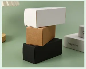 Stack of small cardboard packaging boxes in white, kraft, and black for cosmetic items