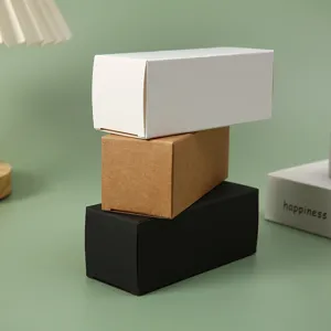 Stacked rectangular kraft paper boxes in white, black, and brown for cosmetic packaging