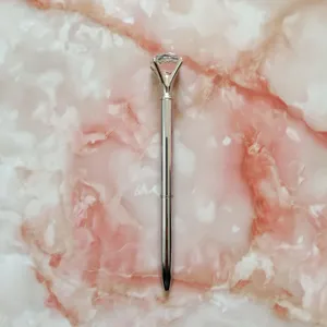 Elegant silver metal ballpoint pen topped with a large clear crystal diamond.