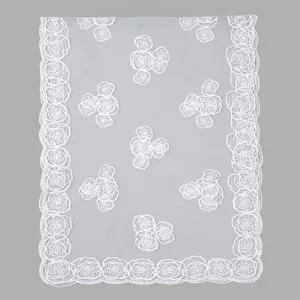 Detailed view of white lace embroidered rose pattern on delicate mesh fabric shawl scarf.