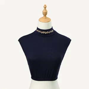Detail view of a navy blue mock neck detachable collar featuring elegant rhinestone chevron details.