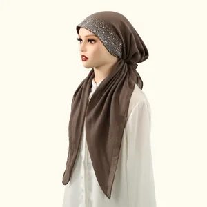 Detail view of brown cotton linen hijab with sparkling rhinestone decoration for elegant wear.