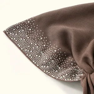 Close up of brown cotton linen hijab cap detail, sparkling rhinestone starry design, soft texture.