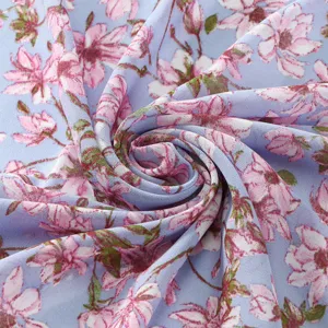 Detailed closeup view of the light blue chiffon fabric featuring an elegant pink floral print pattern.