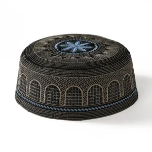 Detailed view of embroidered Muslim prayer cap, black kufi hat with gold blue floral top.