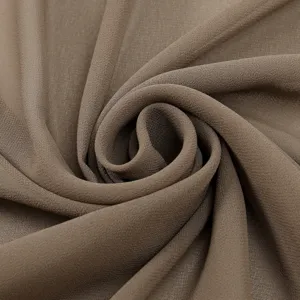Chiffon fabric detail shot showing smooth texture, lightweight drape, and elegant brown color.