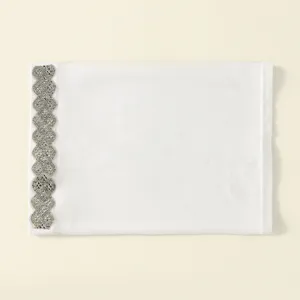 Detailed view of the white polyester tube cap featuring a sparkling rhinestone decorative band.