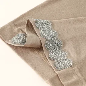 Close-up of rhinestone embellished women hat fabric, elegant shimmering crystal detail style.