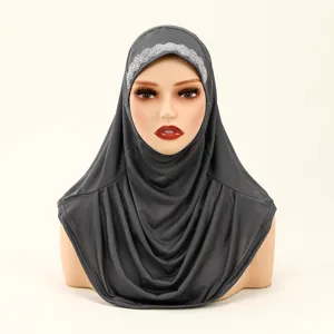 Detail view of women solid dark grey hijab scarf with silver rhinestone forehead accent.