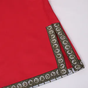 Detail view of red medieval COS costume hem featuring classic gold geometric trim and split design.