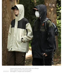 Outdoor couple windbreaker detail view, stylish color block design, casual forest scene.