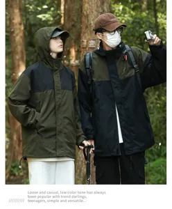 Outdoor scene detail of couple windproof jacket in forest, functional mountaineering coat.
