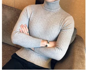 Detailed shot of men's grey turtleneck cable knit sweater showing close-up fabric texture.