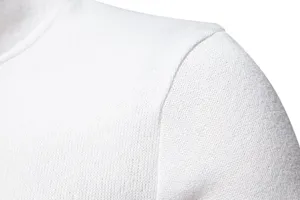 Close-up detail view of the soft white knitted sweater shoulder and collar texture.