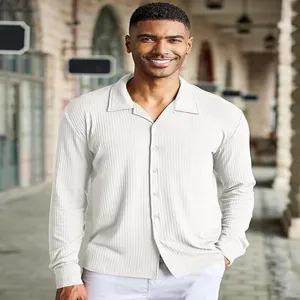 Detailed view of the men's white long sleeve button-up shirt with textured fabric.
