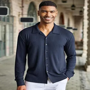 Detail view of men's dark blue ribbed long sleeve shirt with lapel collar and buttons.