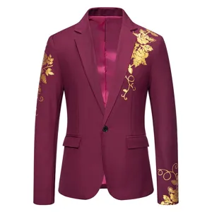 Gold floral print detail on burgundy men's suit jacket sleeve and chest close up view